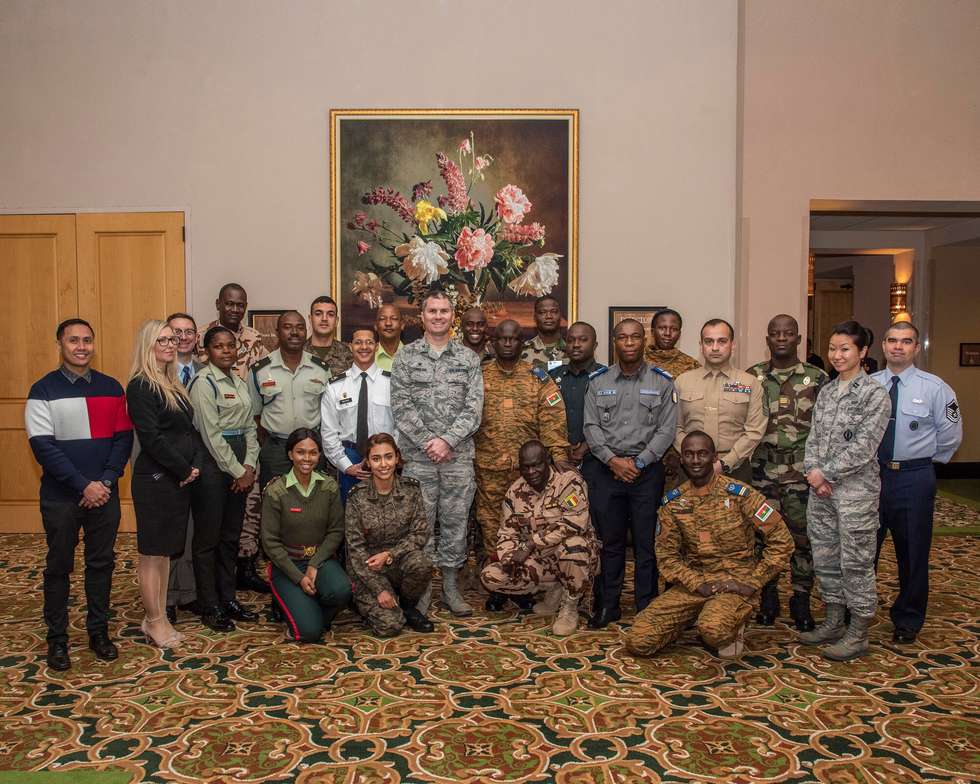 A group of international officers and senior non-commissioned officers from ten Nations within the United States African Command area of responsibility pose for a photo with members of the 960th Cyberspace Wing at the Gateway Club at Joint Base San Antonio, Texas, Feb. 28.