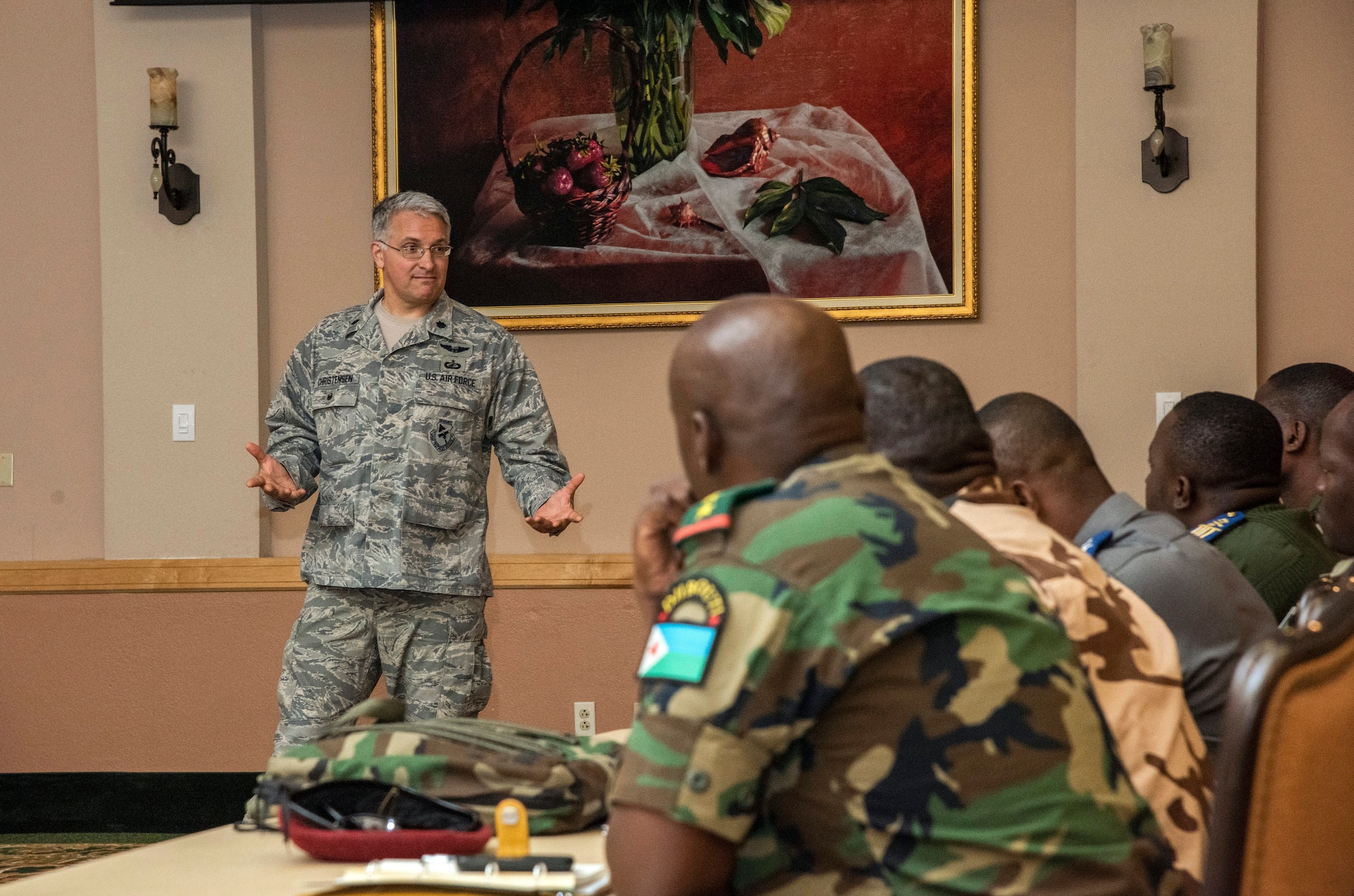 Lt. Col. Michael Christensen, an instructor at the Profession of Arms Center of Excellence, briefs a group of international offcers and senior non-commissioned officers on how to handle a vraiety of ethical dilemmas they may face as they manage people within a military organization.