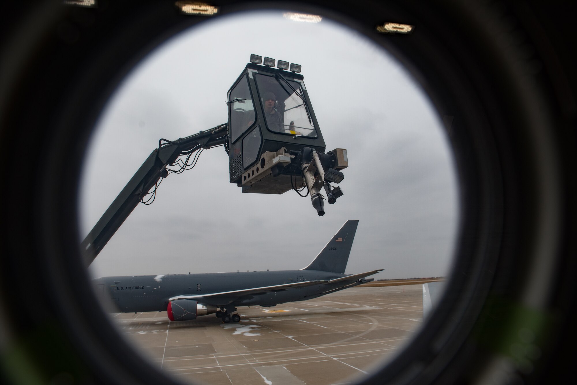 Airman 1st Class Thomas Hawkins, 22nd Aircraft Maintenance Squadron aerospace propulsion journeyman, de-ices the wing of a KC-46A Pegasus at McConnell Air Force Base, Kan., Feb. 28, 2019. Snow had to be removed from the aircraft before it could be cleared to fly its first local sortie since the Air Force accepted the new weapon system Jan. 25, 2019. (U.S. Air Force photo by Staff. Sgt. David Bernal Del Agua)