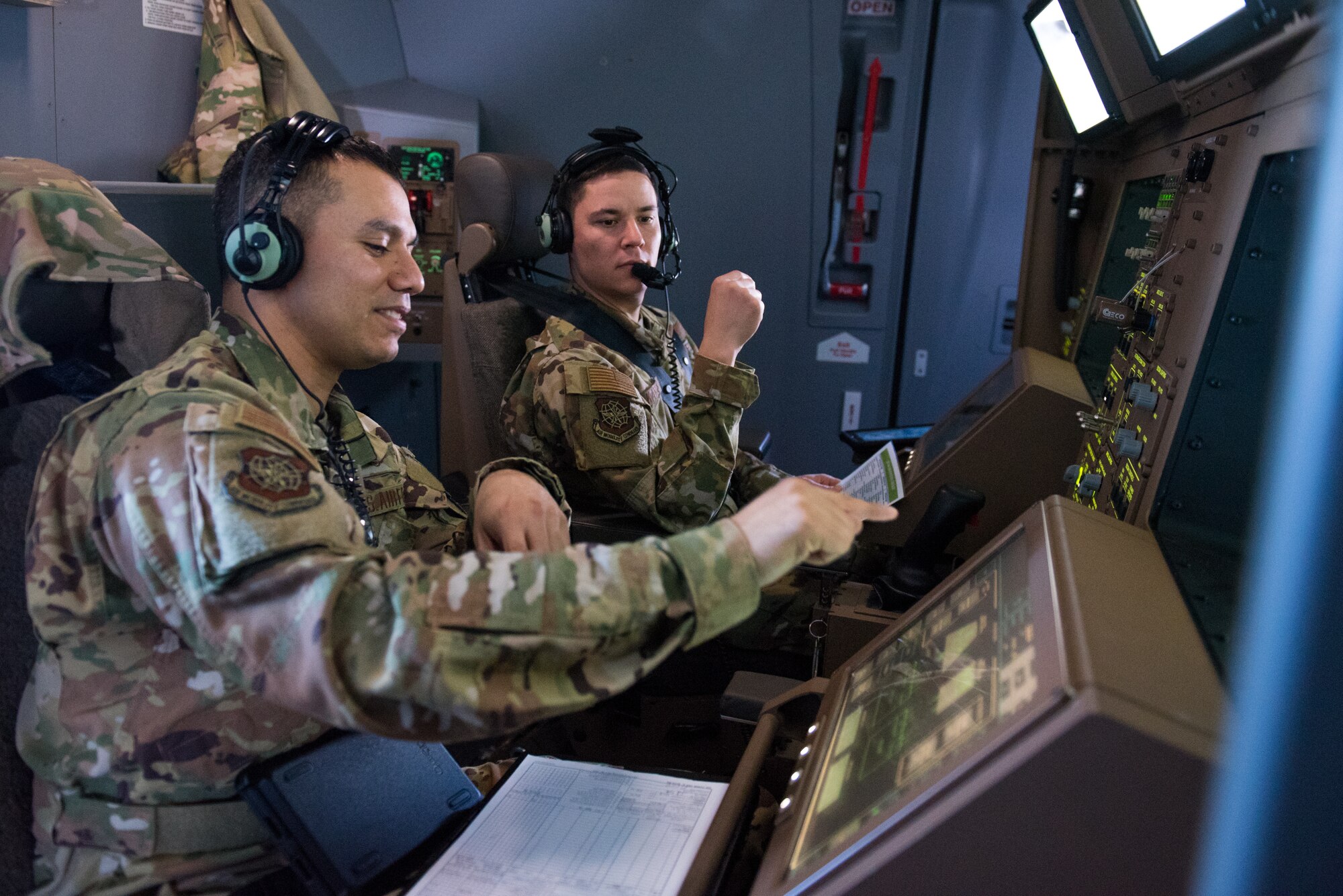 Master Sgt. Edward Soto, 344th Air Refueling Squadron boom operator, left, follows an air refueling checklist over the skies of Oklahoma, Feb. 28, 2019. Master Sgt. Devin Kay, 344th ARS instructor boom operator, watched as Soto ran through the checklist according to Boeing and Air Force rules of operation for the new aircraft accepted Jan. 25, 2019. (U.S. Air Force photo by Staff. Sgt. David Bernal Del Agua)