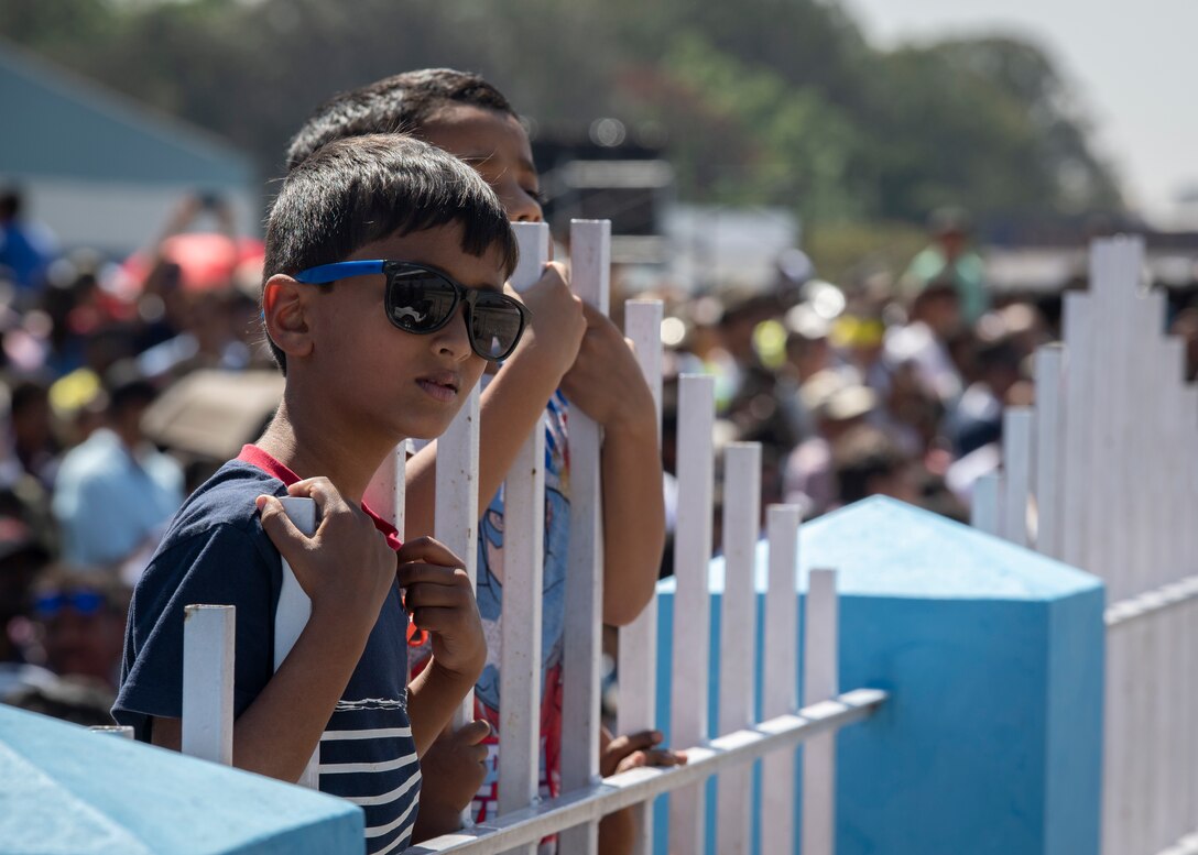 An airshow attendant watches a C-17 Globemaster III demonstration flight during Aero India 2019 at Air Force Station Yelahanka, Bengaluru, India, Feb. 23, 2019.