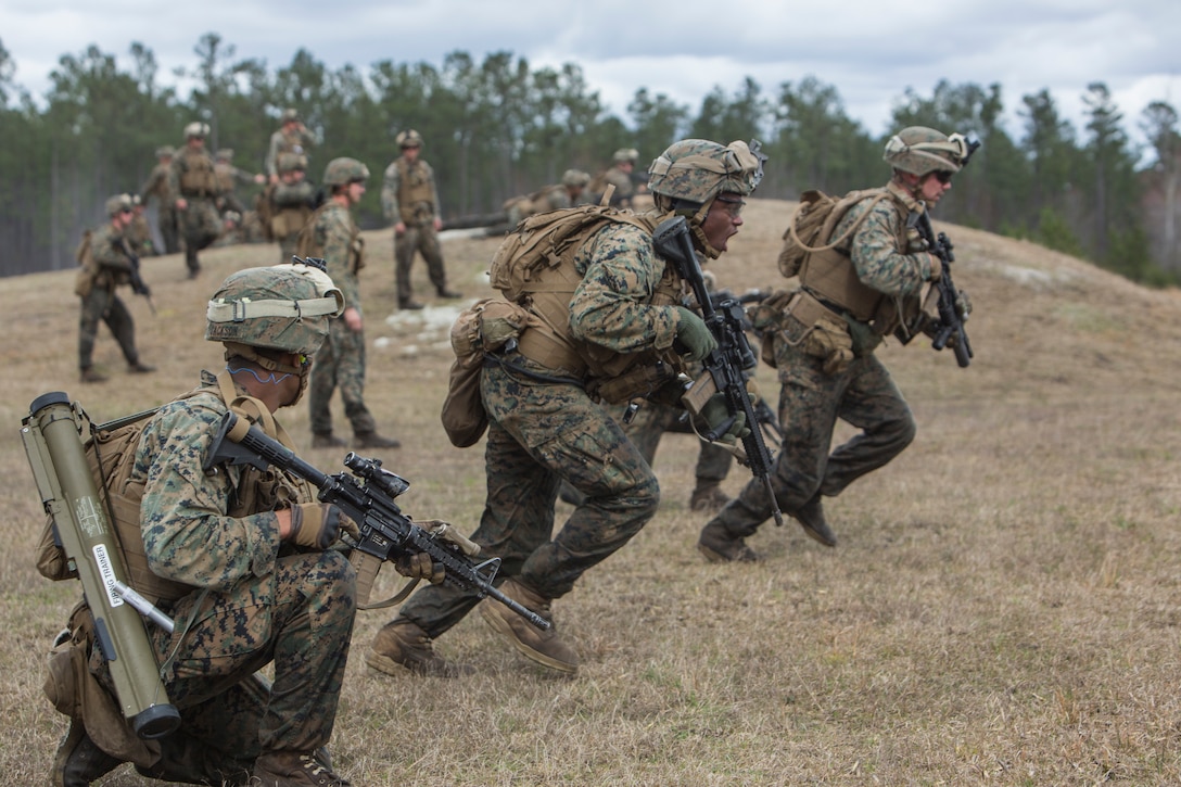 Marines run  as a group.