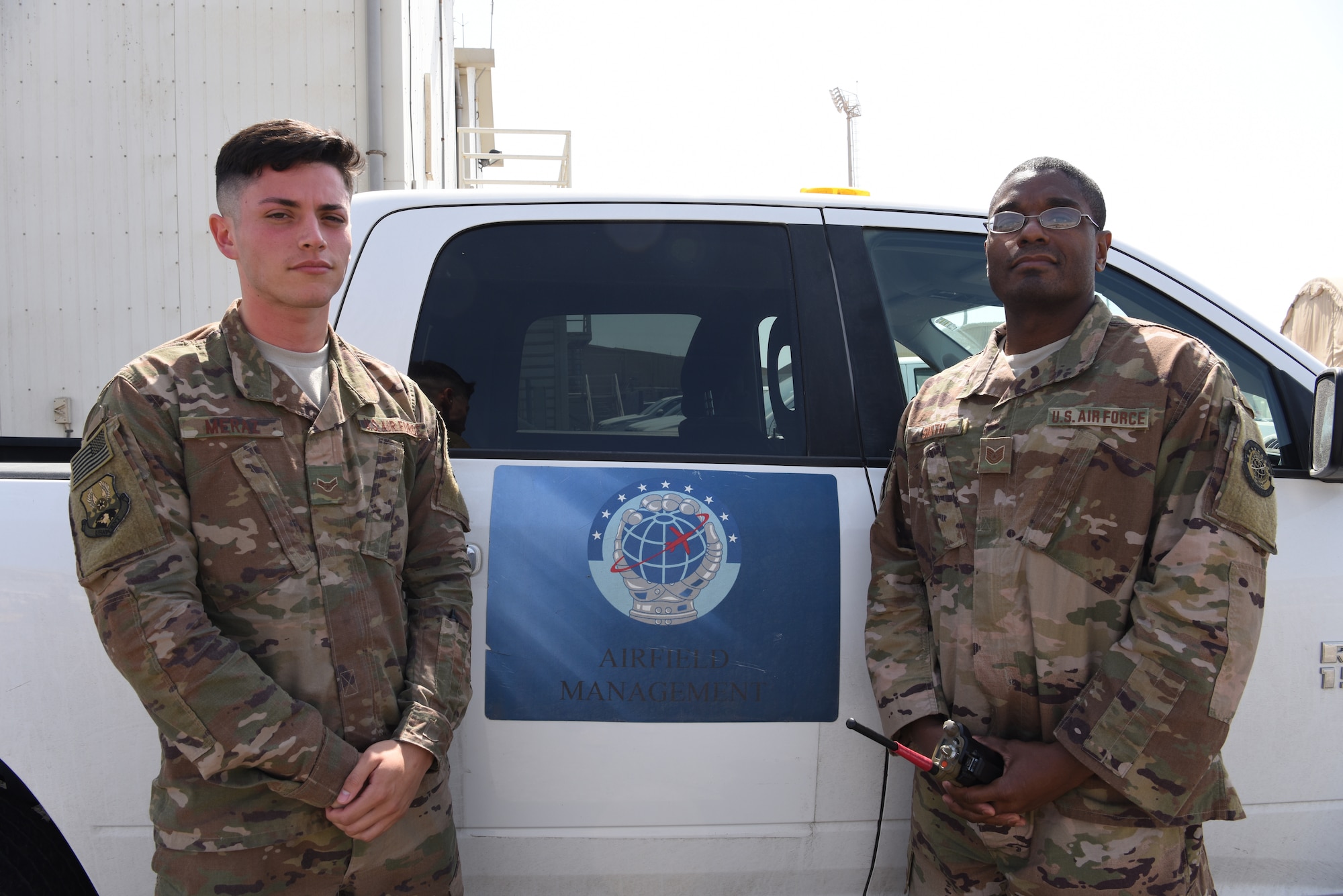 Airman 1st Class Jesse Meraz, 380th Expeditionary Operational Support Squadron airfield management operations coordinator and Tech. Sgt. Antwan Smith, 380th EOSS NCOIC of airfield management, pose for a photo at Al Dhafra Air Base, United Arab Emirates, Feb. 26, 2019.