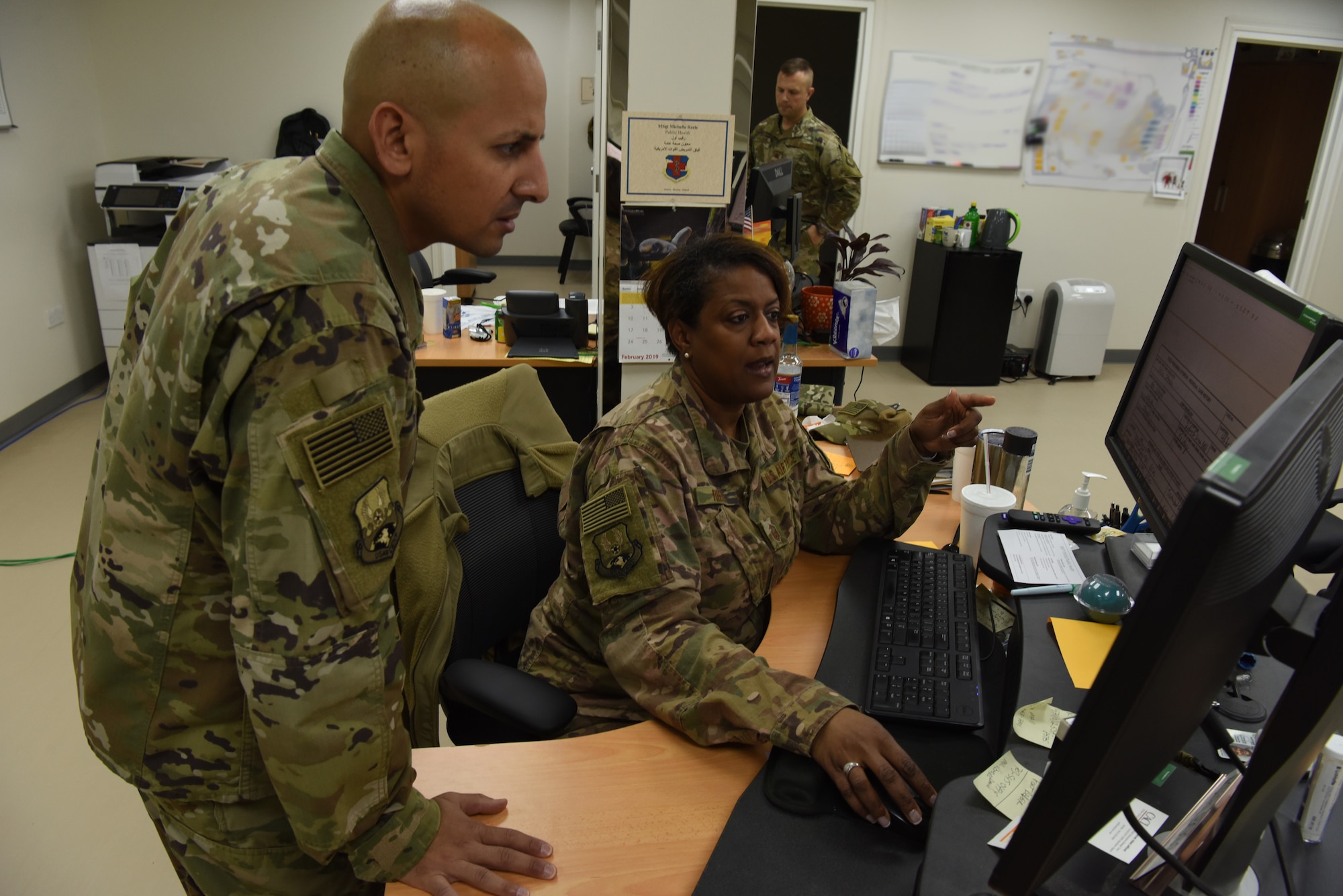 Capt. Brett Vallecillo, 380th Expeditionary Medical Group public health public health officer, and Master Sgt. Lolita Reels, 380th EMDG public health craftsman, review medical information to determine the source of the simulated patients during a public health exercise at Al Dhafra Air Base, United Arab Emirates, Feb 18-22, 2019.