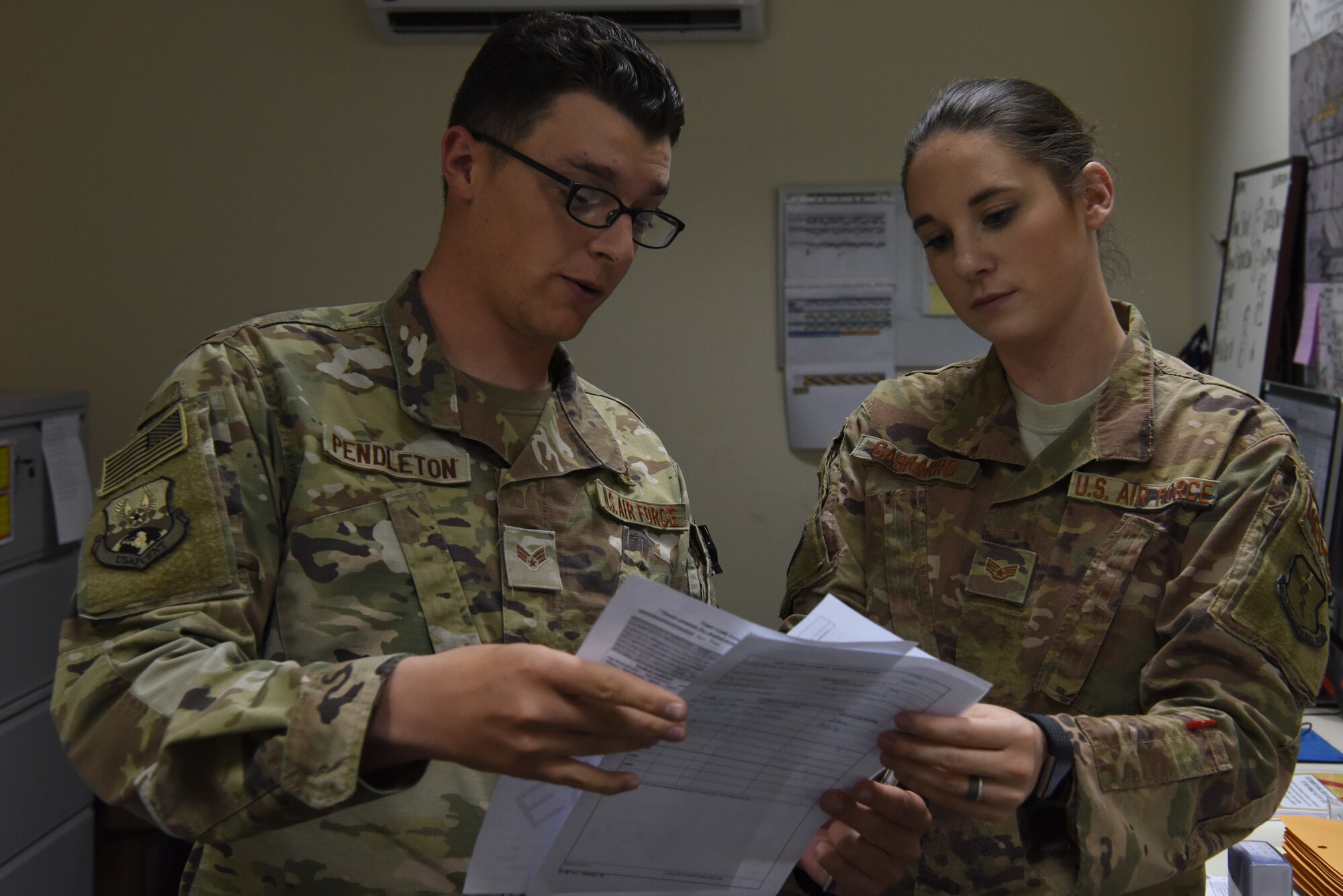 Senior Airman Albert Pendleton, 380th Expeditionary Security Forces Squadron force protection member and at home station works in aerospace medical technician, and Staff Sgt. Casey Gasbarro, 380th EMDG flight and operational medical technician, examine a simulated patient’s evaluation during the public health exercise at Al Dhafra Air Base, United Arab Emirates, Feb 18-22, 2019.