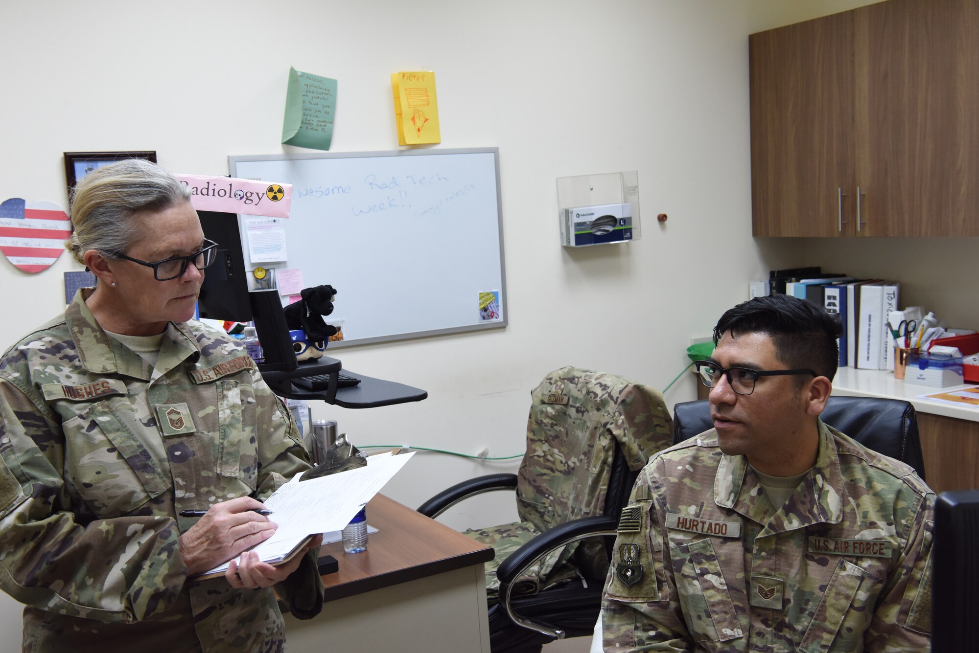 Senior Master Sgt. Patricia Hughes, 380th Expeditionary Medical Group superintendent of public health and evaluator, asks questions to Staff Sgt. Vincent Hurtado, 380th EMDG laboratory technician, as part of the public health exercise at Al Dhafra Air Base, United Arab Emirates, Feb 18-22, 2019.
