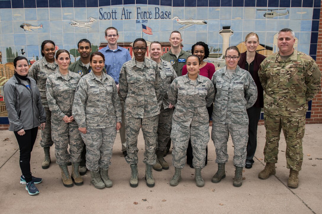 932nd Airlift Wing leadership, Col. Michael Cruff, commander, far right and Chief Master Sgt. Barbara Gilmore, command chief, far left pose with the newest citizen Airmen to join team Scott, March 2, 2019, Scott Air Force Base, Illinois. Leadership welcomes newcomers and gives a briefing about the 932nd AW mission, leadership, groups and answers questions each month. (U.S. Air Force photo by Senior Airman Brooke Deiters)