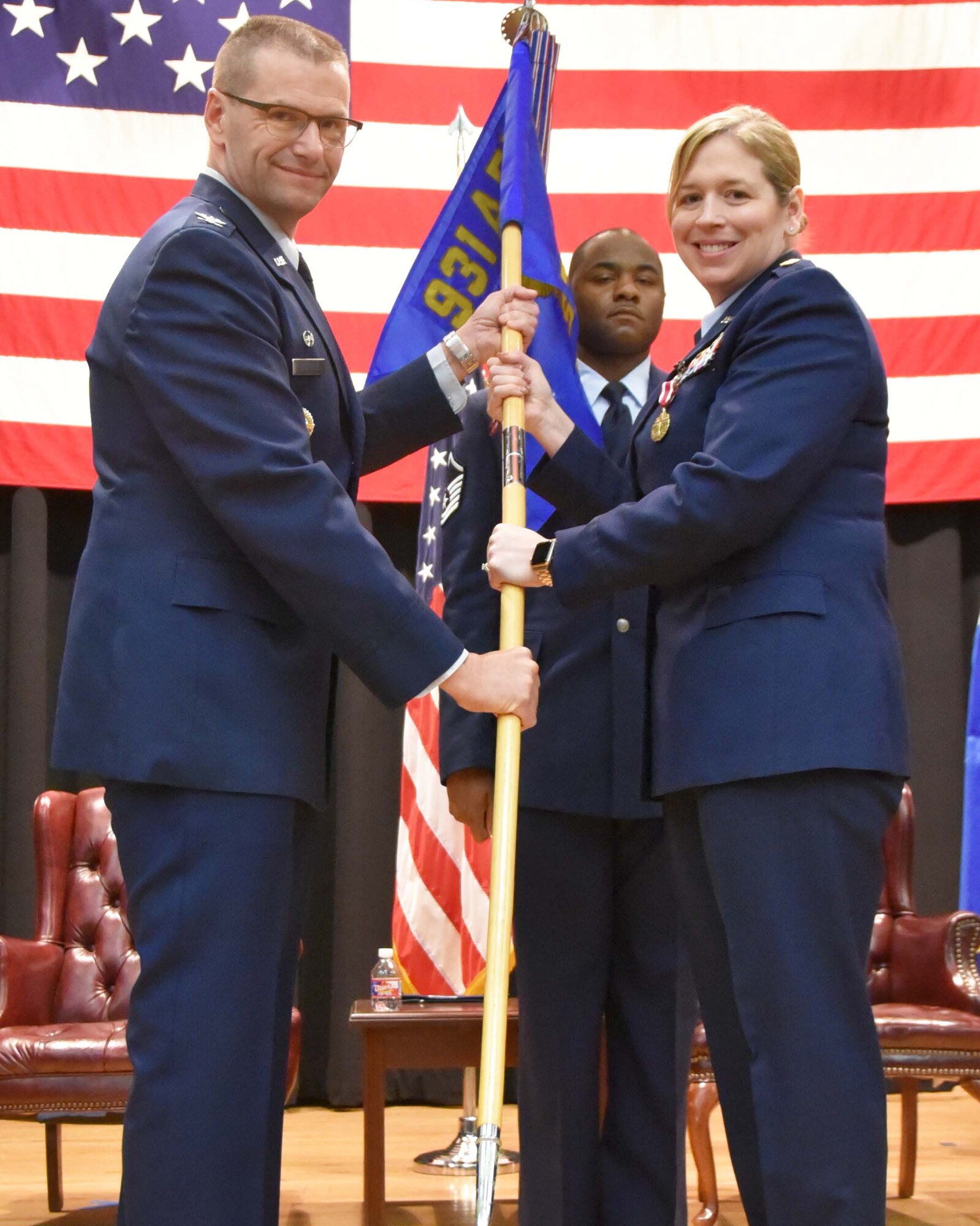(Left to right) Col. Phil Heseltine, 931st Air Refueling Wing commander, takes the guidon from Maj. Amy White, outgoing 931st Force Support Squadron commander, during an official change of command ceremony March 2, 2019, McConnell Air Force Base, Kan.  White has commanded the 931 FSS since 2015.