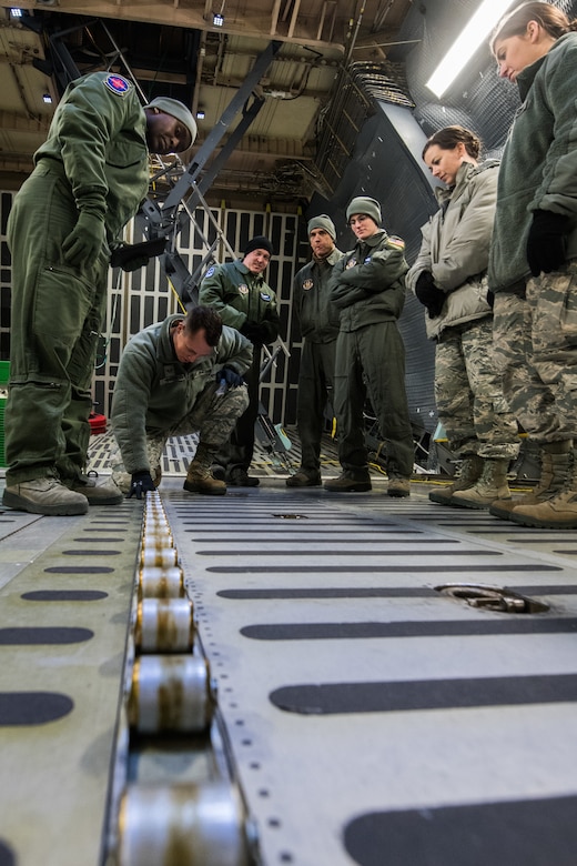 Senior Airman Adam Heyden, 932nd Aeromedical Evacuation Squadron, learns how to prevent tripping hazards in the cargo hold of the C-5M Super Galaxy, March 2, 2019, Scott Air Force Base, Illinois. The training prepares AES members to become more efficient in transferring patients on the C-5M Super Galaxy. (U.S. Air Force photo by Senior Airman Brooke Deiters)