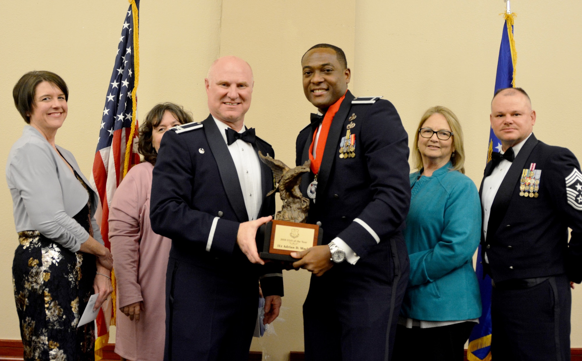 Col. Miles Heaslip, 507th Air Refueling Wing commander, and Chief Master Sgt. David Dickson, 507th ARW command chief, along with wing community partners, present the 507th ARW Company Grade Officer of the Year award to 1st Lt. Adrian Mack, 507th Aircraft Maintenance Squadron, March 2, 2019, in Midwest City, Oklahoma. (U.S. Air Force photo by Maj. Jon Quinlan)