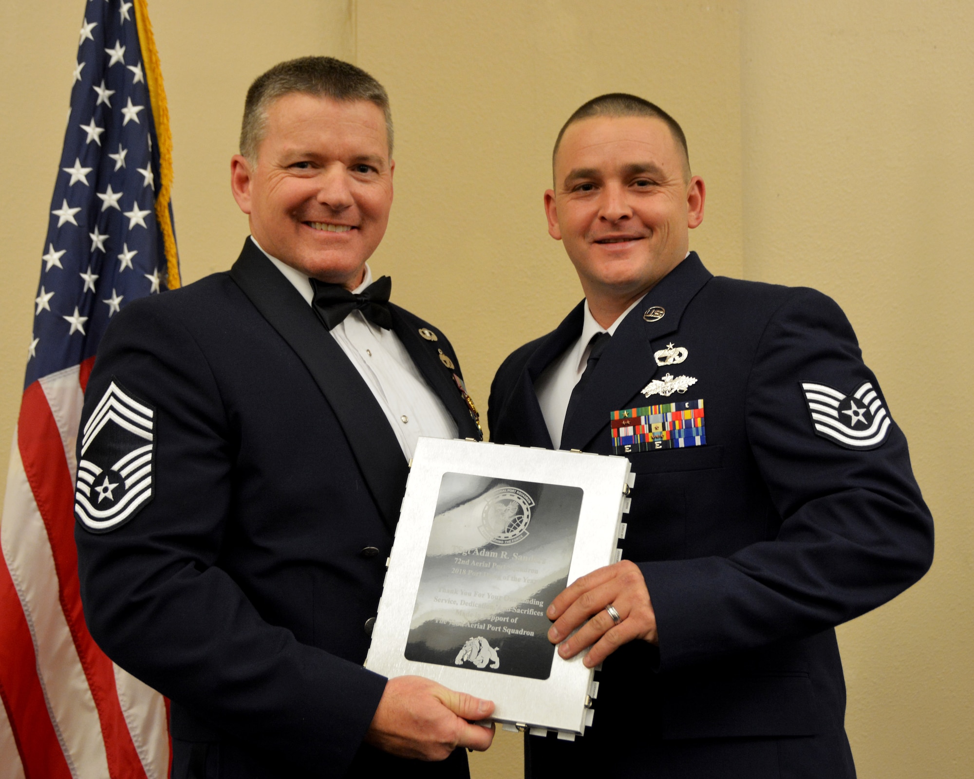 Chief Master Sgt. Michael Knight, 72nd Aerial Port Squadron, presents the 2018 72nd APS Port Dawg of the Year award for outstanding performance to Tech. Sgt. Adam Sanders March 2, 2019, in Midwest City, Oklahoma. (U.S. Air Force photo by Maj. Jon Quinlan)