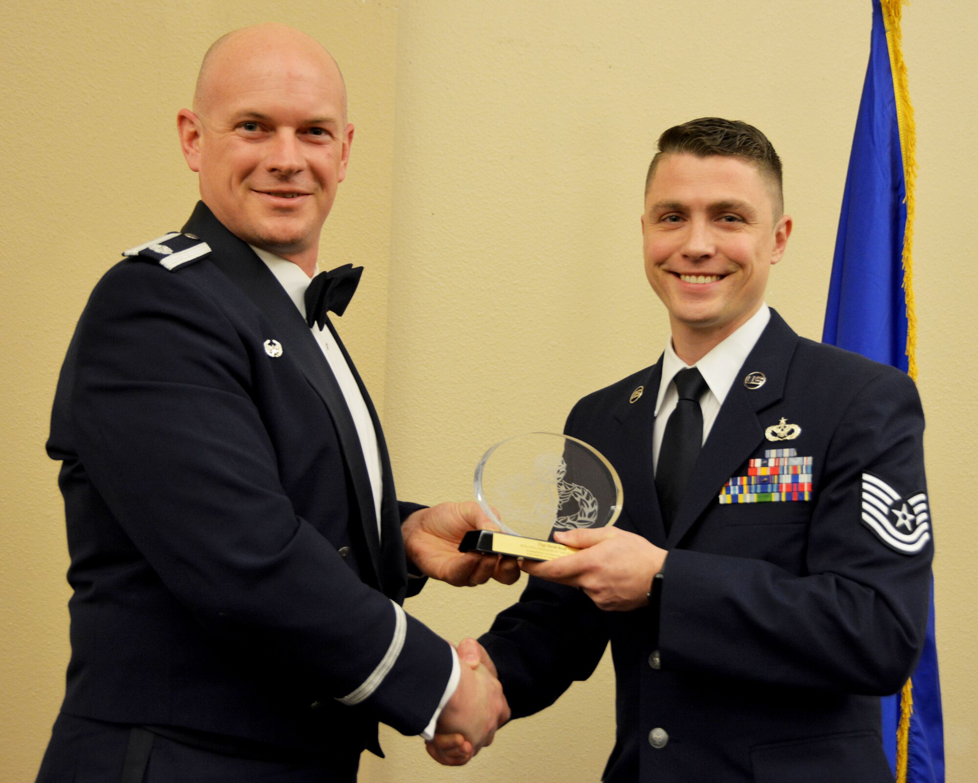Lt. Col. Dustin Born, 507th Civil Engineer Squadron commander, presents the 2018 507th CES Civil Engineer of the Year award for outstanding performance to Tech. Sgt. David Reed March 2, 2019, in Midwest City, Oklahoma. (U.S. Air Force photo by Maj. Jon Quinlan)