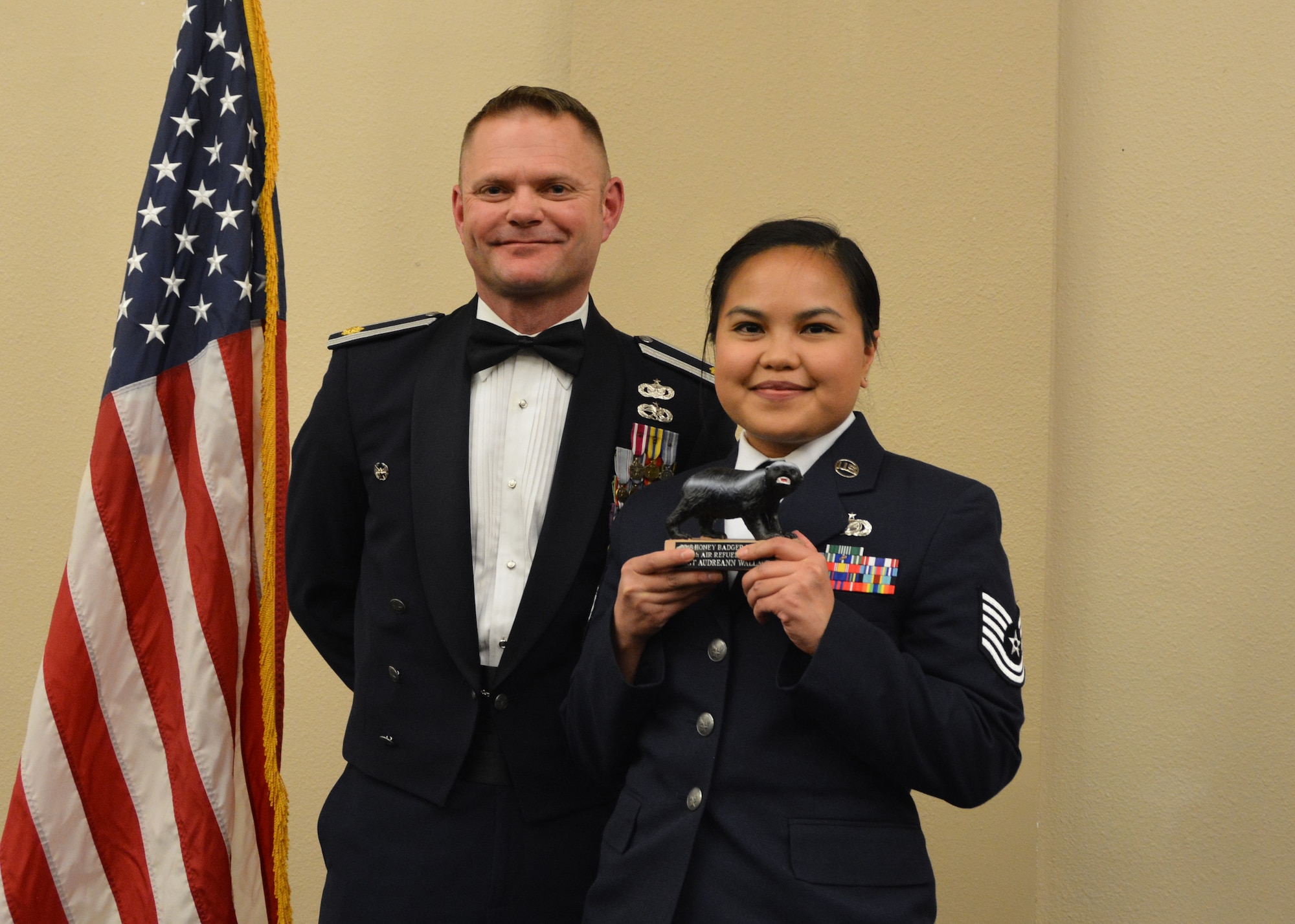 Maj. Patrick Mitchell, 507th Air Refueling Wing executive officer, presents the 2018 507th ARW Wing Staff Honey Badger Trophy for outstanding performance to Tech. Sgt. Audreann Wallace March 2, 2019, in Midwest City, Oklahoma. (U.S. Air Force photo by Maj. Jon Quinlan)