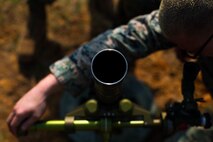 U.S. Marine Corps Cpl. Chase Kreucher with Tactical Readiness Training (TRT) Platoon, Combat Logistics Regiment 37, 3rd Marine Logistics Group, adjusts a 60 mm mortar round at Range 10, Camp Schwab, Okinawa, Japan on Feb. 26, 2019. TRT Platoon fired the M224 60 mm mortar system to maintain proficiency in order to remain combat ready for worldwide deployments. (U.S. Marine Corps photo by Lance Cpl. Isaiah Campbell)