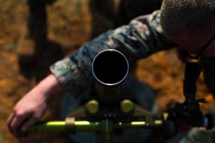 U.S. Marine Corps Cpl. Chase Kreucher with Tactical Readiness Training (TRT) Platoon, Combat Logistics Regiment 37, 3rd Marine Logistics Group, adjusts a 60 mm mortar round at Range 10, Camp Schwab, Okinawa, Japan on Feb. 26, 2019. TRT Platoon fired the M224 60 mm mortar system to maintain proficiency in order to remain combat ready for worldwide deployments. (U.S. Marine Corps photo by Lance Cpl. Isaiah Campbell)