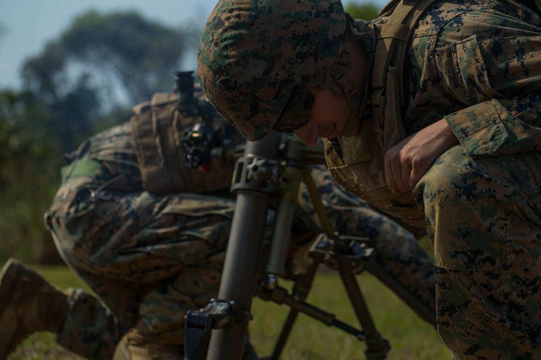 U.S. Marine Corps Cpl. Raul Mendez with Tactical Readiness Training Platoon (TRT), Combat Logistics Regiment 37, 3rd Marine Logistics Group, fires a 60 mm mortar round at Range 10, Camp Schwab, Okinawa, Japan on Feb. 26, 2019. TRT Platoon fired the M224 60 mm mortar system to maintain proficiency in order to remain combat ready for worldwide deployments. (U.S. Marine Corps photo by Lance Cpl. Isaiah Campbell)