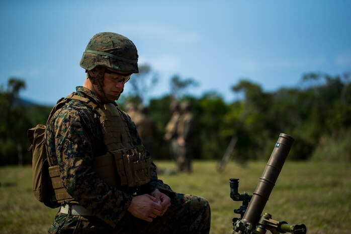 U.S. Marine Corps Cpl. Daniel Divirgilio with Tactical Readiness Training (TRT) Platoon, Combat Logistics Regiment 37, 3rd Marine Logistics Group, prepares to fire a 60 mm mortar round at Range 10, Camp Schwab, Okinawa, Japan on Feb. 26, 2019. TRT Platoon fired the M224 60 mm mortar system to maintain proficiency in order to remain combat ready for worldwide deployments. (U.S. Marine Corps photo by Lance Cpl. Isaiah Campbell)