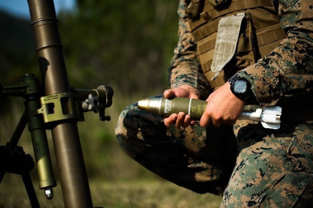 U.S. Marine Corps Capt. Moises E. Navas with Tactical Readiness Training (TRT) Platoon, Combat Logistics Regiment 37, 3rd Marine Logistics Group, prepares to fire a 60 mm mortar round at Range 10, Camp Schwab, Okinawa, Japan on Feb. 26, 2019. TRT Platoon fired the M224 60 mm mortar system to maintain proficiency in order to remain combat ready for worldwide deployments. (U.S. Marine Corps photo by Lance Cpl. Isaiah Campbell)