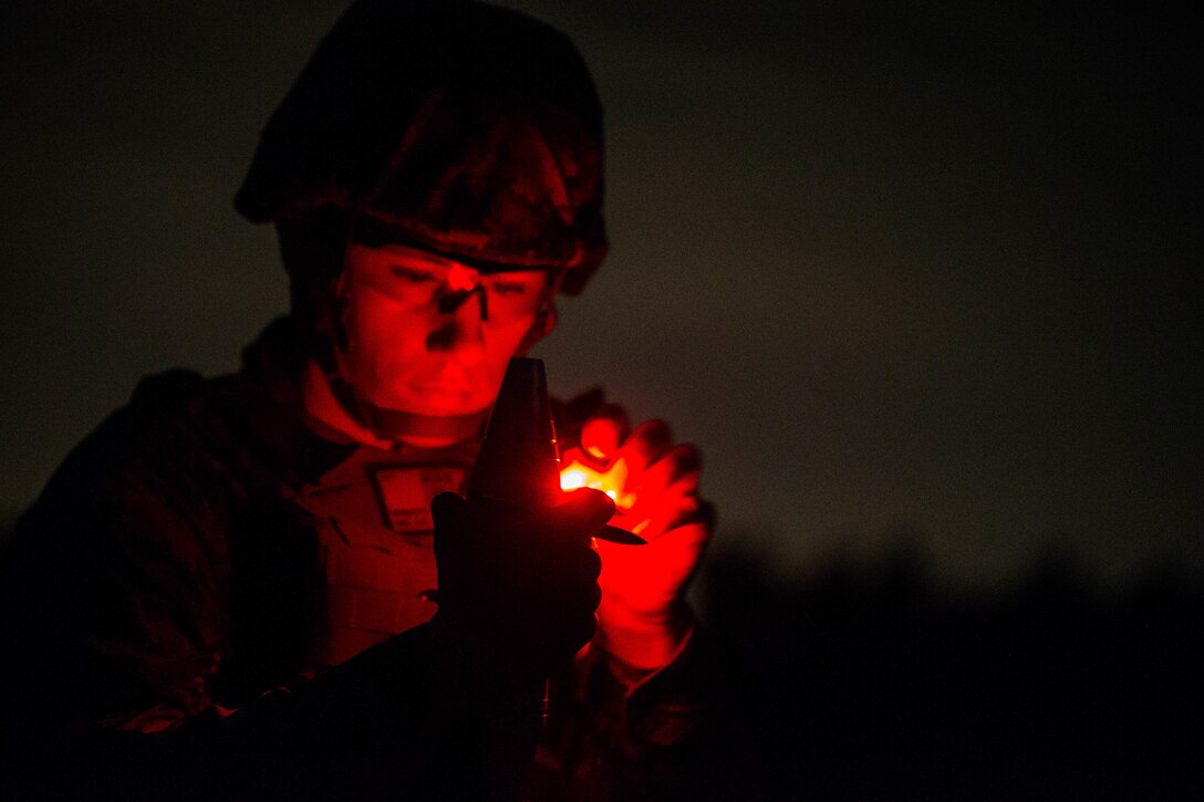 U.S. Marine Corps Cpl. Keagan Walsh with Tactical Readiness Training Platoon (TRT), Combat Logistics Regiment 37, 3rd Marine Logistics Group, inspects an illumination mortar round at Range 10, Camp Schwab, Okinawa, Japan on Feb. 26, 2019. TRT Platoon fired the M224 60 mm mortar system to maintain proficiency in order to remain combat ready for worldwide deployments. (U.S. Marine Corps photo by Lance Cpl. Isaiah Campbell)