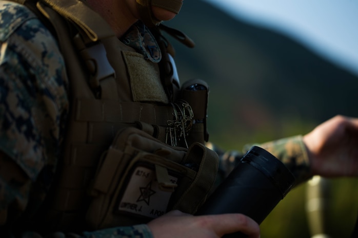 U.S. Marine Corps Lance Cpl. Joe Lowther with Tactical Readiness Training (TRT) Platoon, Combat Logistics Regiment 37, 3rd Marine Logistics Group, prepares 60 mm mortar round at Range 10, Camp Schwab, Okinawa, Japan on Feb. 26, 2019. TRT Platoon fired the M224 60 mm mortar system to maintain proficiency in order to remain combat ready for worldwide deployments. (U.S. Marine Corps photo by Lance Cpl. Isaiah Campbell