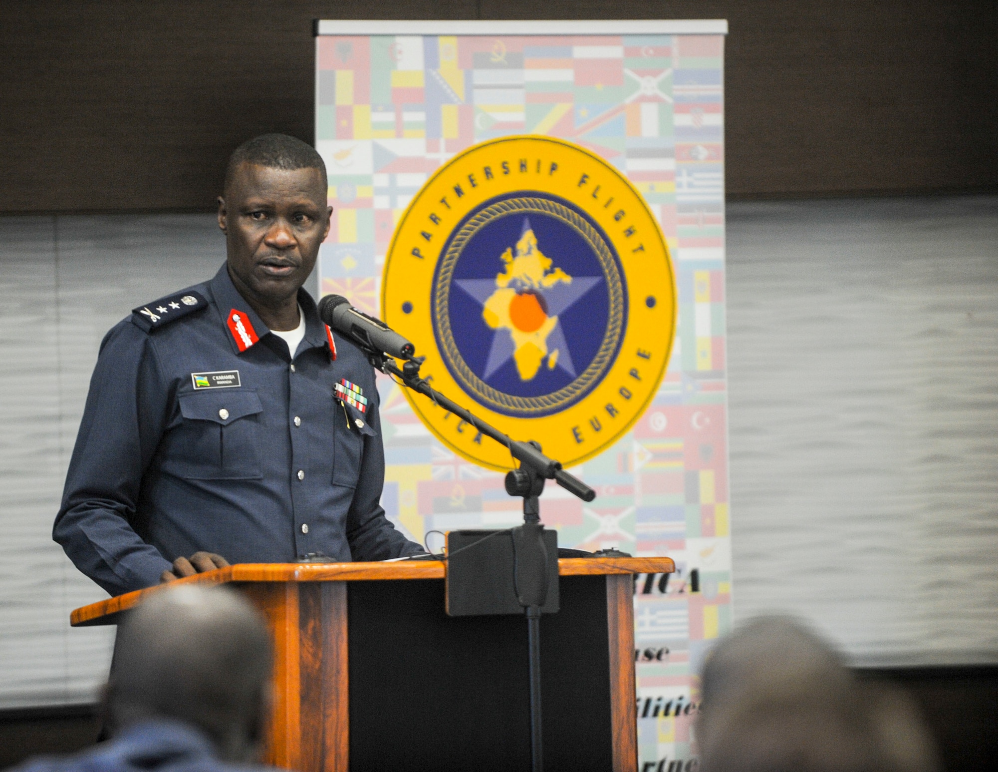 Rwanda Air Force Air Chief, Maj. Gen. Charles Karamba gives remarks during the African Partnership Flight Rwanda opening ceremony in Kigali, Rwanda, March 4, 2019. The APF program is intended to build strong, transparent partnerships that enhance regional stability and security. APF Rwanda's focus is on sharing best practices for flight, ground, and weapon safety. (U.S. Air Force photo by Tech. Sgt. Timothy Moore)