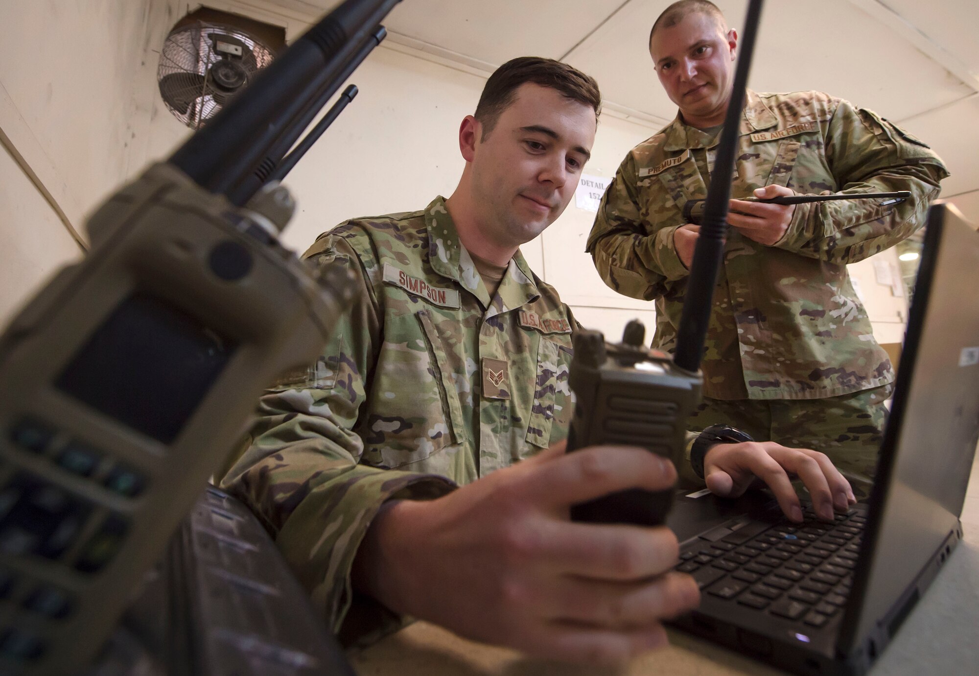 Senior Airman Joseph Simpson, (foreground) 379th Expeditionary Communications Squadron (ECS) radio frequency transmission technician, and Tech. Sgt. Frederick Premuto, 379th ECS 379th ECS radio frequency transmission NCO in charge, check communications equipment for a coalition partner facility Feb. 8, 2019, at Al Udeid Air Base, Qatar. Simpson and Premuto are part of a “beddown” team that enables power projection by establishing communications capabilities such as networks, Voice over Internet Protocol telephones, and radios from the ground up (U.S. Air Force photo by Tech. Sgt. Christopher Hubenthal)