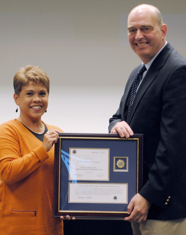 Charmaine Camper, director of expeditionary contracting in DLA Joint Contingency Acquisition Support Office, receives her certificate for completing the Insights into Industry Course from DLA Acquisition Director Matthew Beebe.