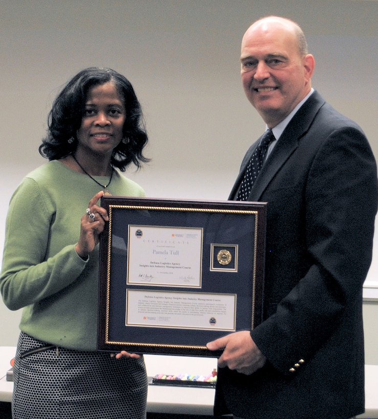 DLA Troop Support Integrative Supply Team Chief Supervisor Pamela Tull receives her certificate for completing the Insights into Industry Course from DLA Acquisition Director Matthew Beebe.
