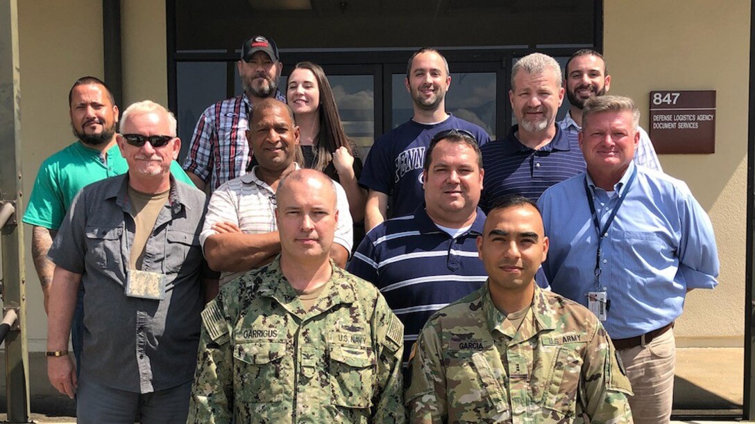 DLA Rapid Deployment Team White, led by Navy Capt. Mark Garrigus (front left), poses for a picture at Maxwell Air Force Base, Alabama, while deployed in support of Hurricane Florence.