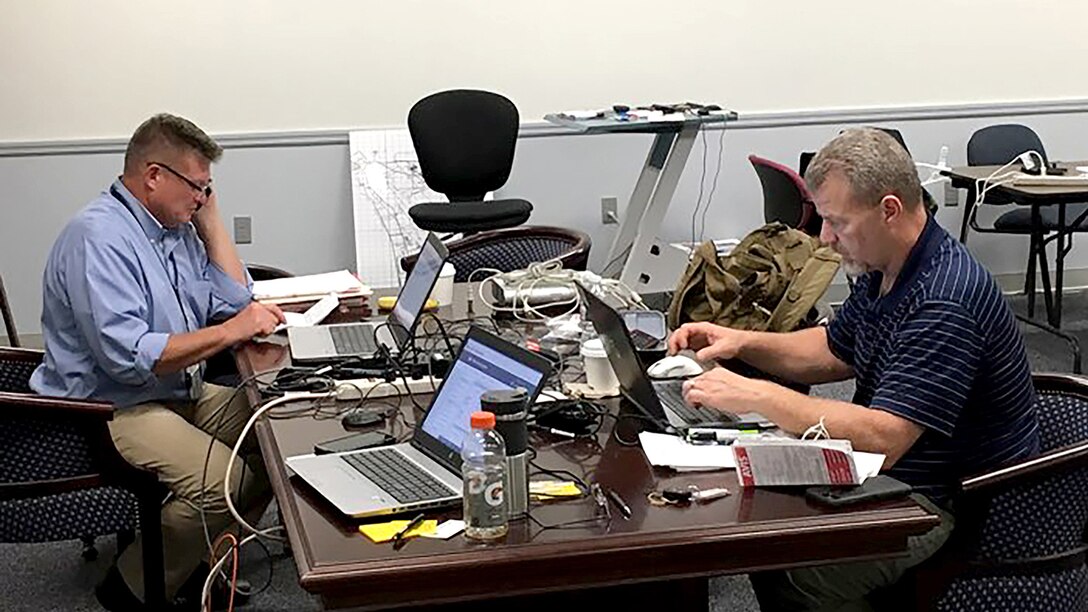 Deputy commander of Task Force Atlantic, Robert Bednarcik, and Operations Officer Robert Hays work command and control functions while forward deployed to Gunter Annex of Maxwell Air Force Base in Montgomery, Alabama, during Hurricane Florence.