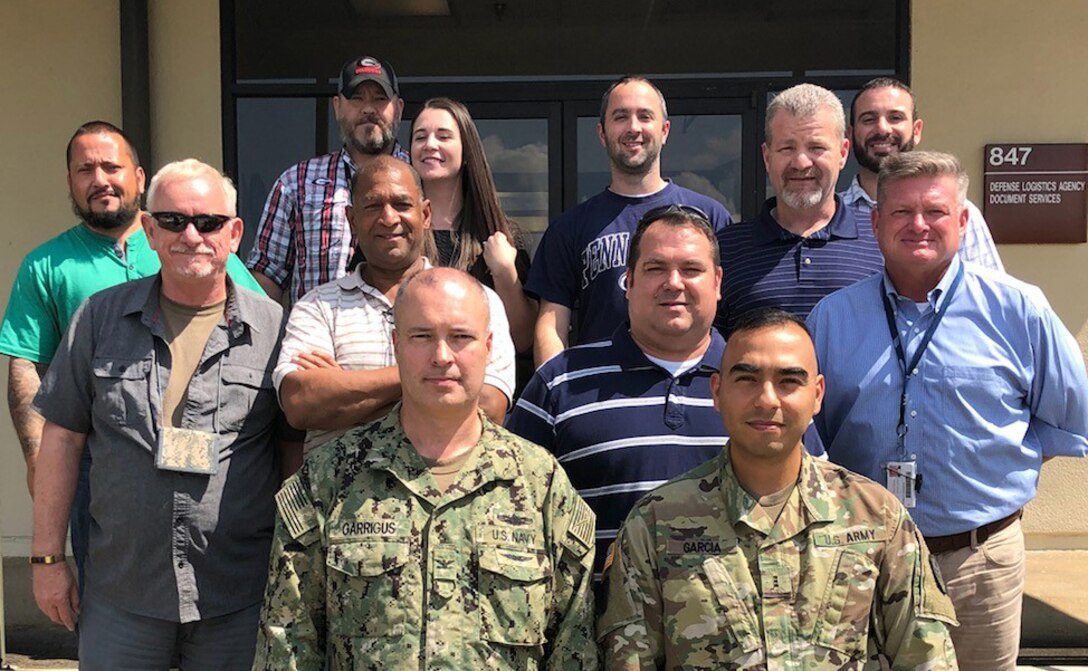 DLA Rapid Deployment Team White, led by Navy Capt. Mark Garrigus (front left), poses for a picture at Maxwell Air Force Base, Alabama, while deployed in support of Hurricane Florence.