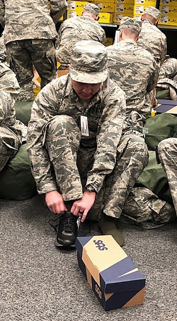 An Air Force recruit at Joint Base San Antonio-Lackland, Texas, tries on athletic shoes provided by DLA during initial uniform issuance in January. Almost 2,800 Airmen were issued athletic footwear along with other uniform items including utility uniforms, boots and undergarments.