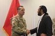 Col. Manuel Ocasio, 1st Mission Support Command, U.S. Army Reserve-Puerto Rico deputy commander (left) shakes hands with U.S. Rep. Alexander Green, member of the House Homeland Security Committee, (right), shortly after the Army Reserve-PR presentation, March 2, at Fort Buchanan.
