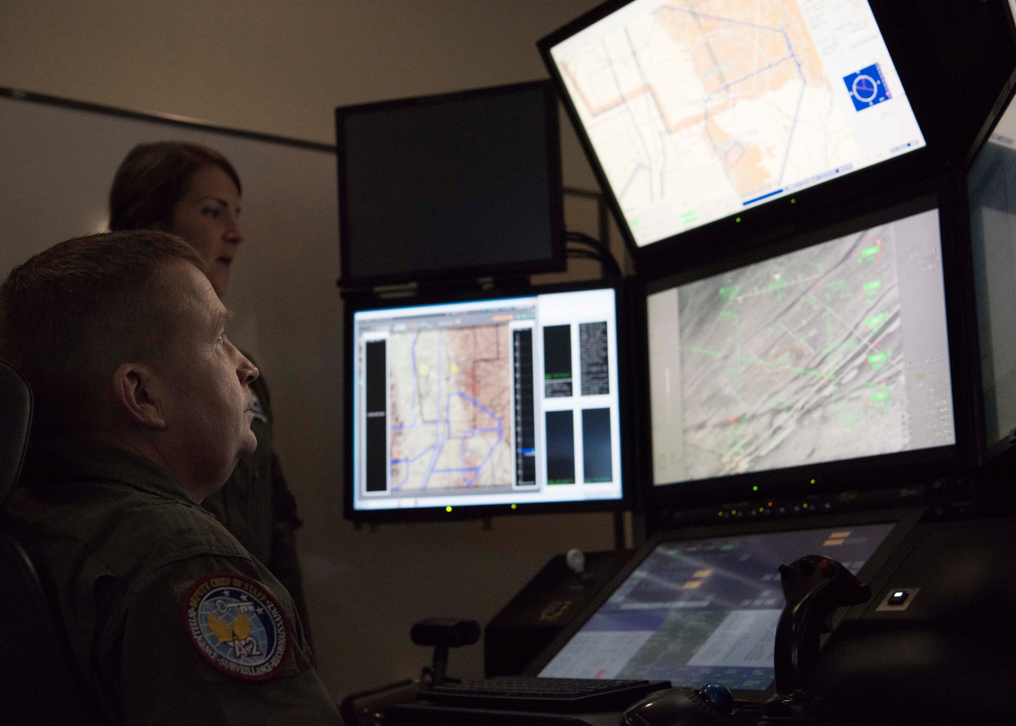 Capt. Amanda Collazzo, 6th Attack Squadron chief of weapons, briefs Brig. Gen. James Cluff, Remotely Piloted Aircraft, Big Wing Intelligence, Surveillance and Reconnaissance director, while he operates a Block 50 MQ-9 Reaper cockpit simulator. The 16th Training Squadron recently upgraded their simulators from the Block 30 model to the Block 50, to keep their training platforms up to date. (U.S. Air Force photo by Staff Sgt. BreeAnn Sachs)