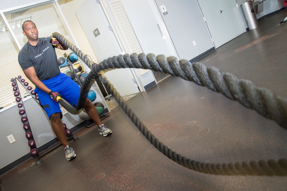 Robert Jackson, mechanical engineer and chairperson of Huntsville Center’s Wellness Committee, gets a morning workout on the battle ropes in the Center’s newly opened gym.