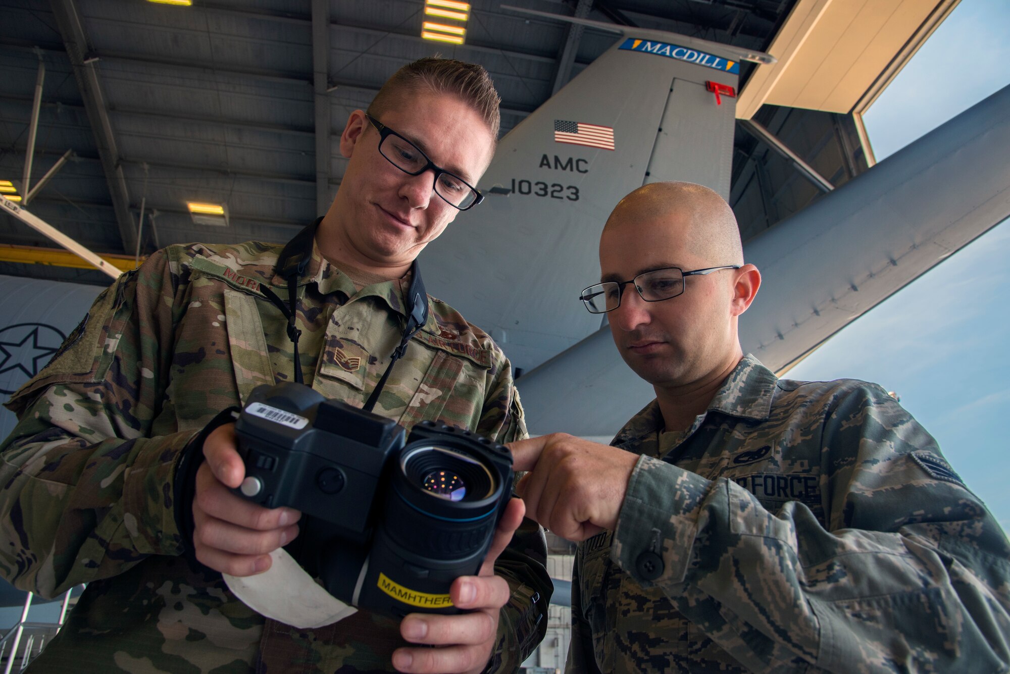 U.S. Air Force Staff Sgt. James Morin, a 6th Aircraft Maintenance thermography certified technician, and Senior Airman John Cuttito, a 6th Maintenance Squadron hydraulics systems journeyman, work together with a thermal imaging camera at MacDill Air Force Base, Fla., March 1, 2019.