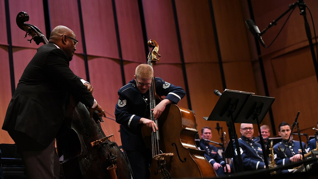 Tech. Sgt. Cameron Kayne, U.S. Air Force Band’s Airmen of Note double bassist, plays with Christian Mcbride, guest double bassist, during the Jazz Heritage Series, Feb. 22, 2019 in Alexandria, Va. This series featured guest double bassist Christian McBride and was conducted by Col. Don Schofield, U.S. Air Force Band commander. (U.S. Air Force photo by Senior Airman Alyssa D. Van Hook)