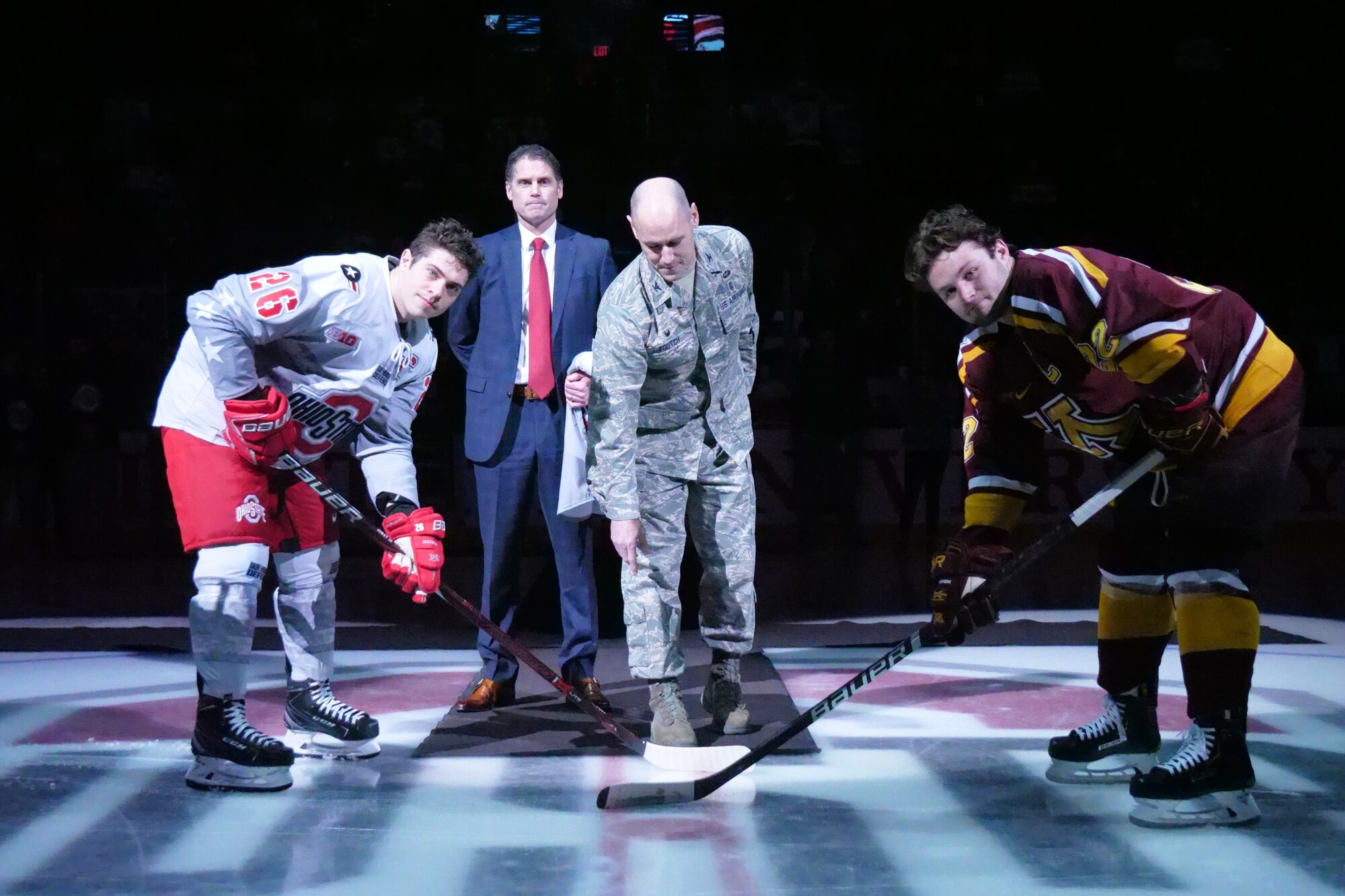 Col. Michael Foutch, 88th Medical Group commander, drops the ceremonial first puck at the Military Appreciation game between the Ohio State Buckeyes and the Minnesota Golden Gophers at the Value City Arena Schottenstein Center in Columbus, Ohio Feb. 15, 2019.