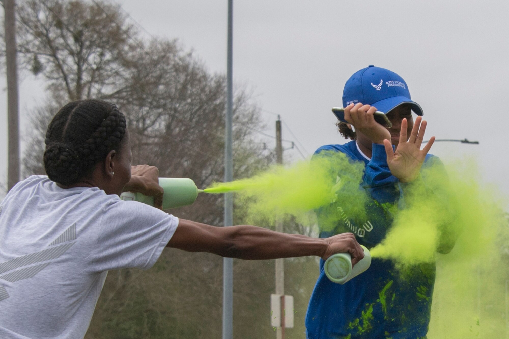 A member of the 307th Bomb Wing's Delayed Entry Program is sprayed  with color by volunteers during the 307th Force Support Squadron's Shamrock 5K at Barksdale Air Force, Louisiana, March 2, 2019. The run was held to encourage fitness, a key factor in the readiness of Reserve Citizen Airmen to deploy when needed. (U.S. Air Force photo by Staff Sgt. Callie Ware)