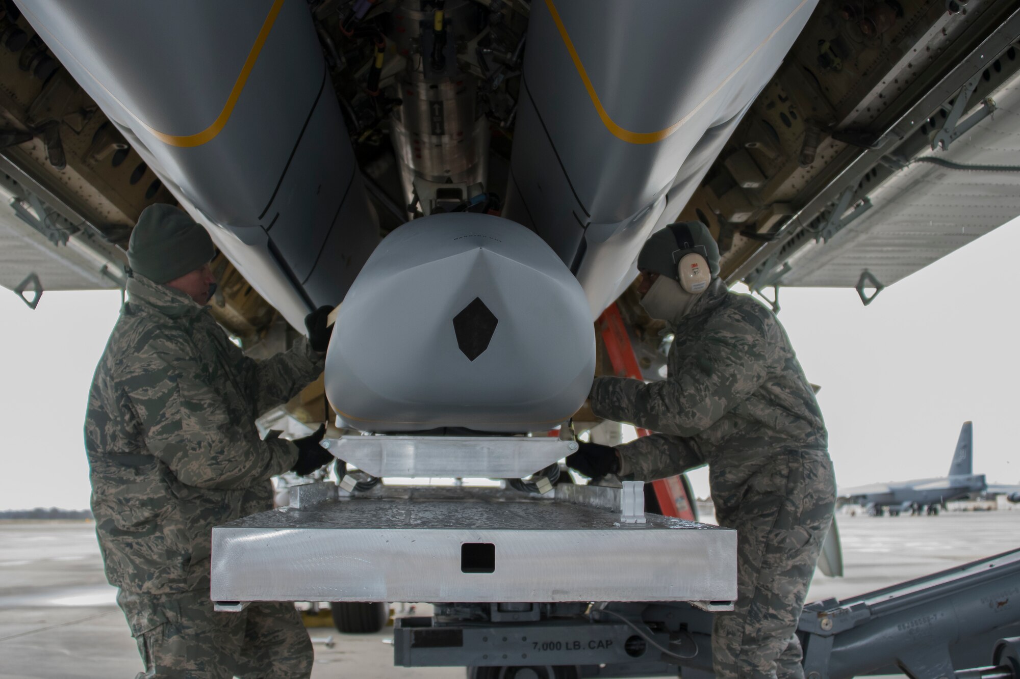 Aircraft armament systems specialists assigned to the 307th Aircraft Maintenance Squadron prepare an AGM-158 Joint Air-to-Surface Standoff Missile on a Conventional Rotary Launcher at Barksdale Air Force Base, Louisiana, February 9, 2019. The munitions were placed on the CRL during a test to see if the weapons platform could power on eight JASSMs at one time.  (U.S. Air Force photo by Airman 1st Class Maxwell Daigle)