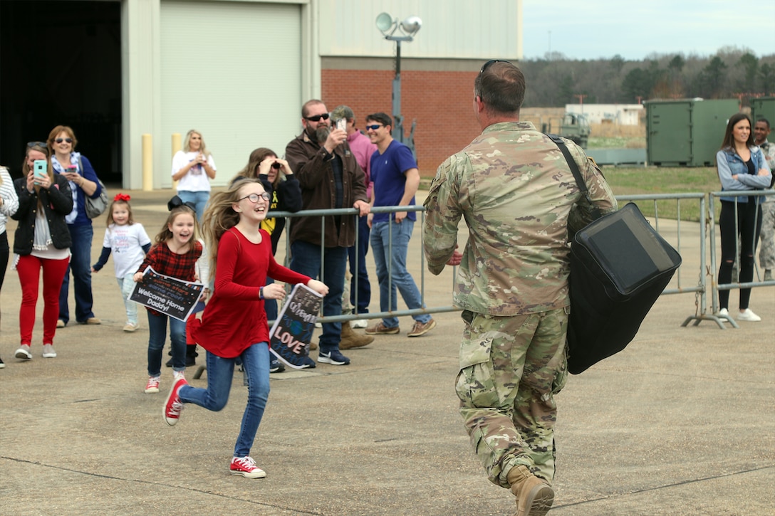 A soldier greets his daughter.