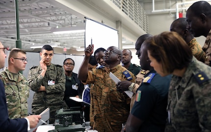 Signal officers and senior non-commissioned officers from the U.S. Africa Command area of responsibility and 56th Signal Battalion Soldiers share knowledge on different communications systems atJoint Base San Antonio-Fort Sam Houston on Feb. 25. Many of the partnered nations officers enjoyed seeing how easily the U.S. Army communications systems could deploy.