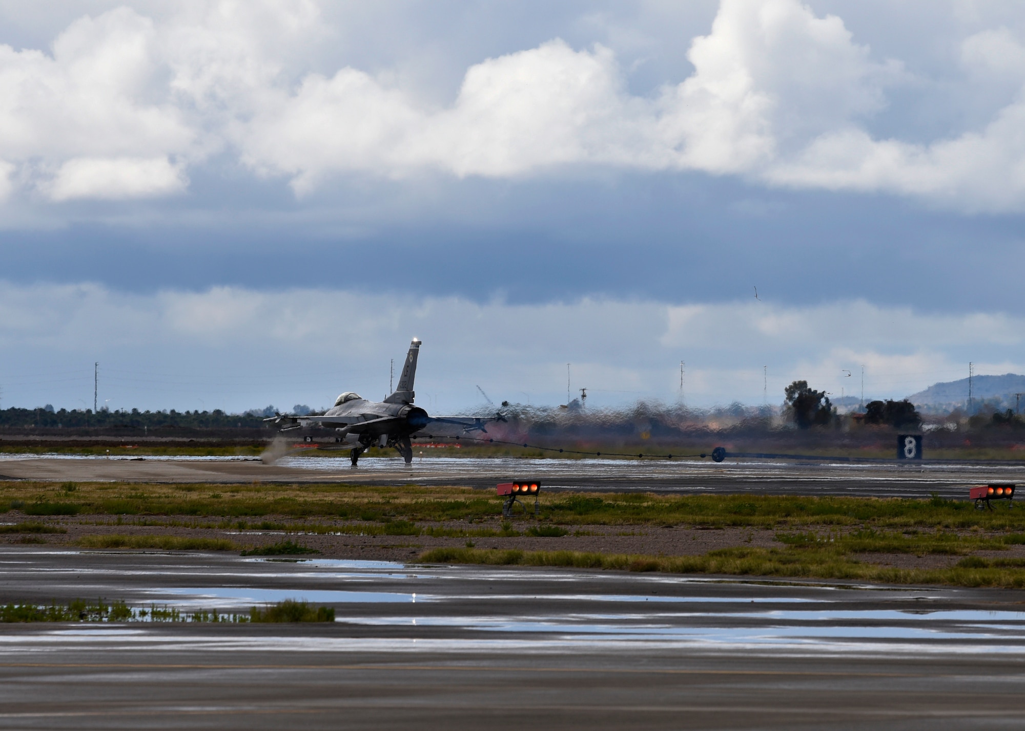 The tail hook on an F-16A Fighting Falcon catches the cable of the BAK-12 arresting system during an annual drill at Luke Air Force Base, Ariz., Feb 22, 2019.