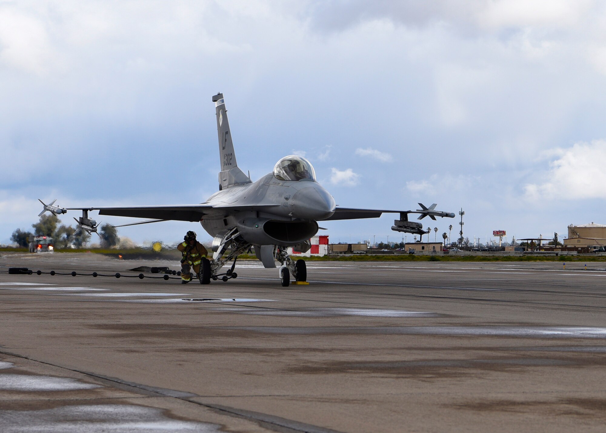 An airman from the 56th Civil Engineer Squadron prepares to release an F-16A Fighting Falcon from a BAK-12 arresting system at Luke Air Force Base, Ariz., Feb. 22, 2019.