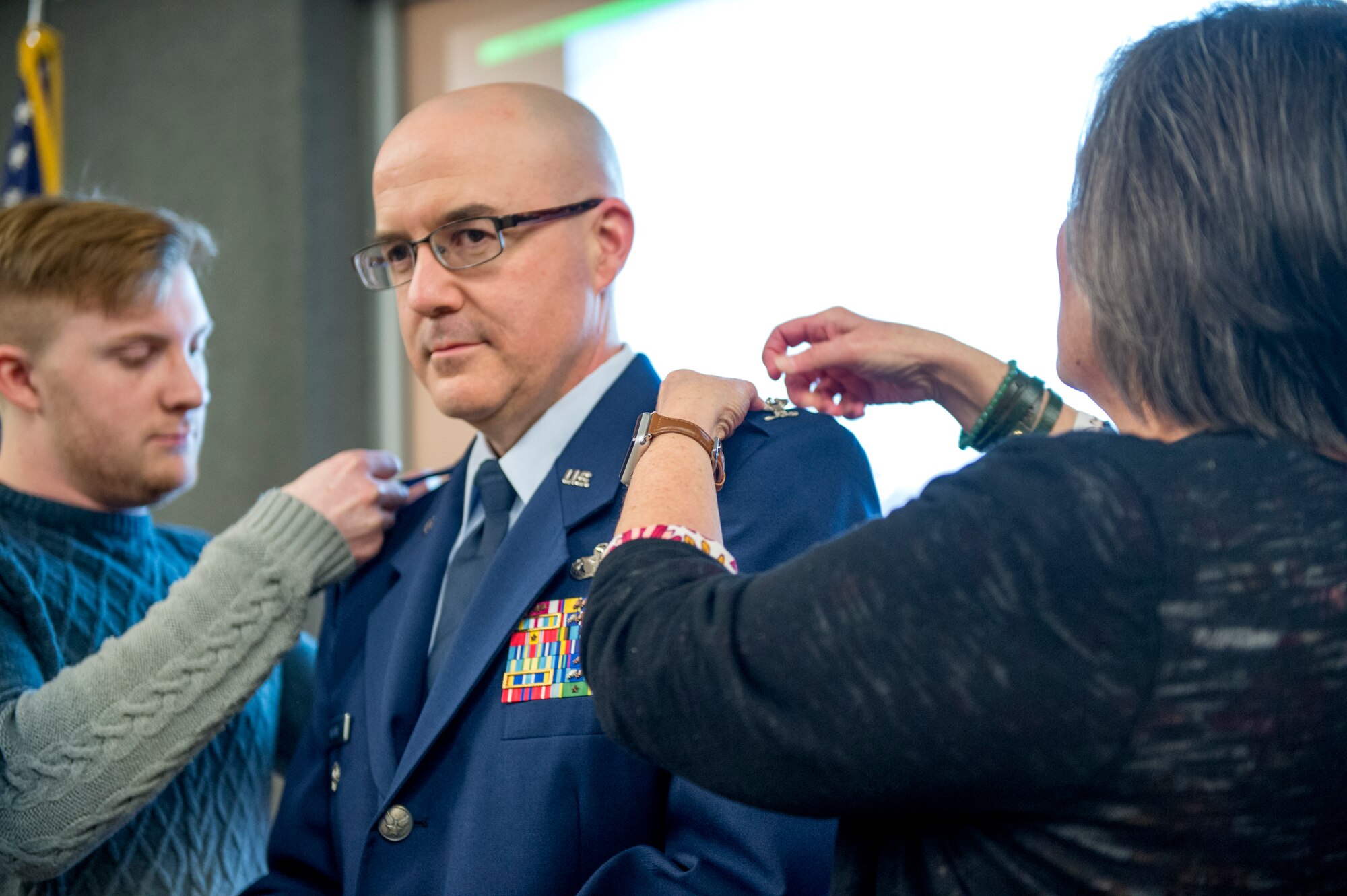 Col. Christopher Witter, 434th Air Refueling Wing director of inspections, has his son Evan, and his wife, Peggy, pin eagle rank insignias on his service dress coat during a pin-on ceremony at Grissom Air Reserve Base, Ind., Feb. 9, 2019. Witter came to Grissom January 2009, serving as the 434th Air Refueling Wing director of inspections. (U.S. Air Force photo/Tech. Sgt. Jami K. Lancette)