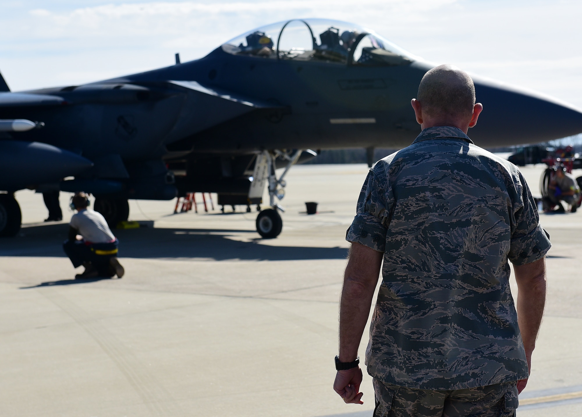Gen. Mike Holmes, commander of Air Combat Command, watches Airmen from the 4th Aircraft Maintenance Squadron load inert weapons onto an F-15E Strike Eagle during training, Feb. 26, 2019, at Seymour Johnson Air Force Base, North Carolina. Holmes was the base commander for Seymour Johnson AFB from August 2004 until September 2006. (U.S. Air Force photo by Senior Airman Kenneth Boyton)
