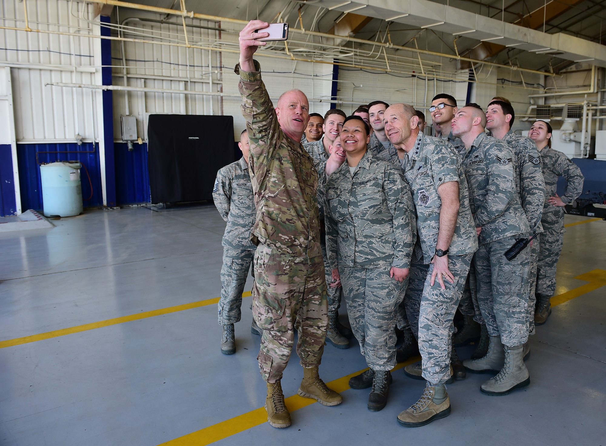 Chief Master Sgt. Frank Batten, command chief of Air Combat Command, holds a phone to take a selfie with Gen. Mike Holmes, commander of ACC, right, and Airmen from the 4th Component Maintenance Squadron, Feb. 26, 2019, at Seymour Johnson Air Force Base, North Carolina. During Holmes’ and Batten’s visit, Airmen shared innovative ideas to help modernize dated practices and find better, more efficient ways of completing the mission across the Air Force. (U.S. Air Force photo by Senior Airman Kenneth Boyton)