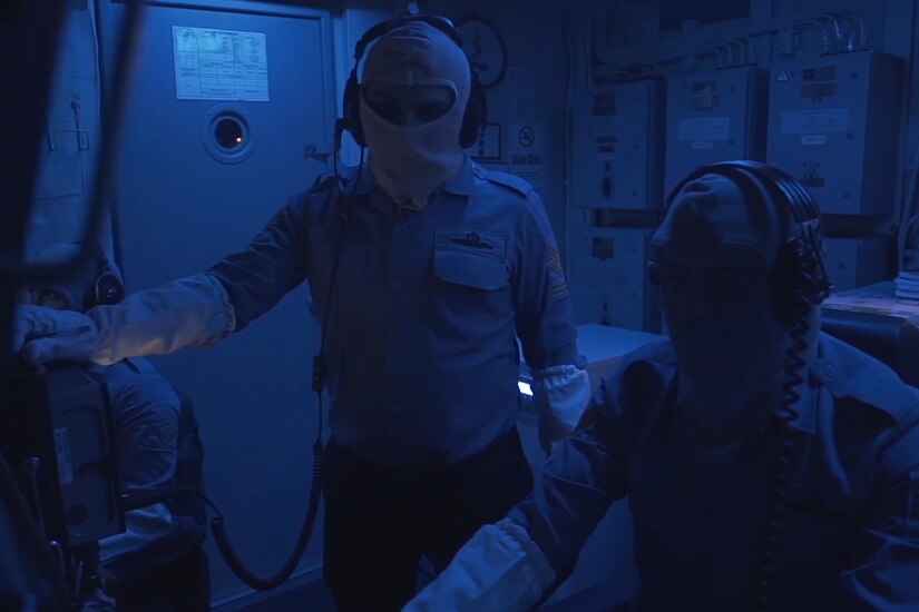 Sailors work to track submarines.