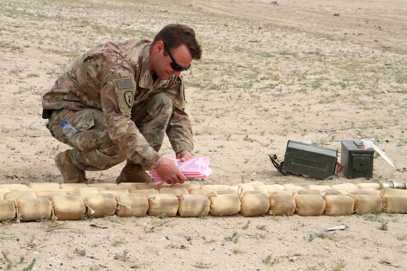 Sergeant Barry Craig, an explosive ordnance disposal team sergeant, 705th EOD Company, Task Force Hellhound, Task Force Spartan, prepares more than 6,800 pounds of unserviceable ammunition to be destroyed in controlled detonation on the Udairi Range, Kuwait, Feb. 27, 2019. Craig, along with other Soldiers and Airmen worked together to transport, place and eventually detonate the unserviceable ammunition in order to provide local ammunition holding areas with more space to store ordnance that can be used for upcoming training events.