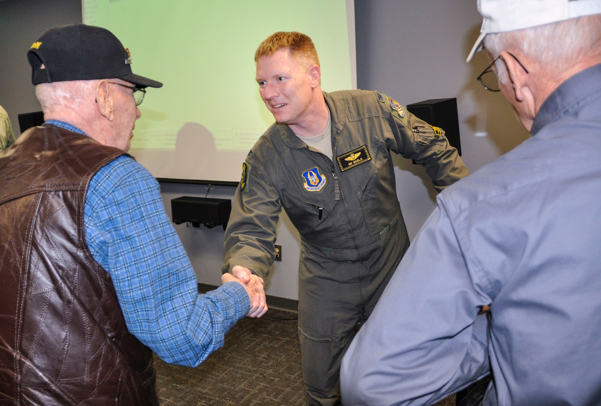 Col. Dan “B.B.” Gable shakes hands with Army Air Corps retiree Tom Fitzgerald after presenting at the Hill Aerospace Museum’s “Plane Talk” series Saturday